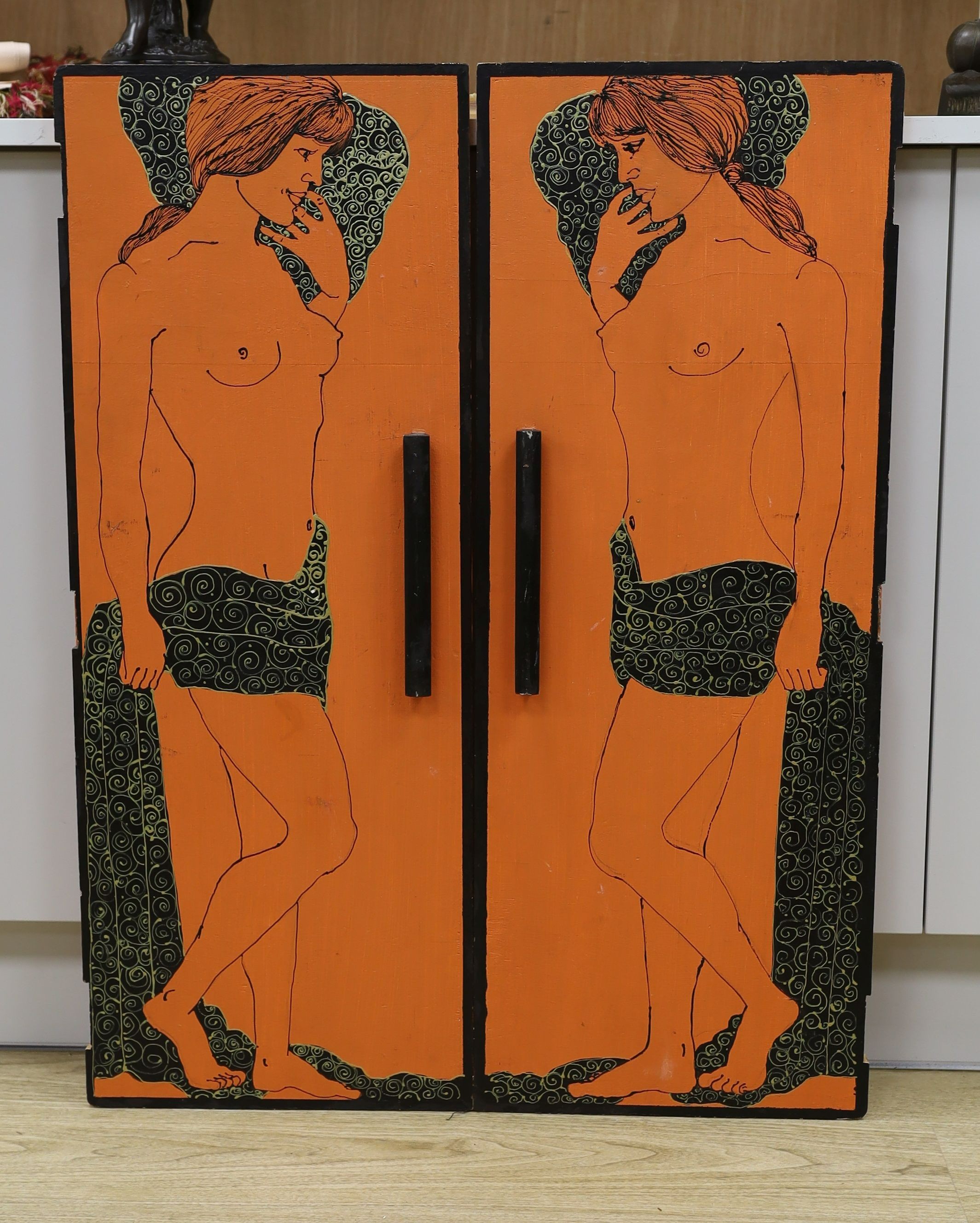 A pair of orange painted figural 1960's cabinet doors, by repute from 'Biba', 36cms wide x94 cms high.